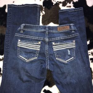 Rock and roll cowgirl riding jeans